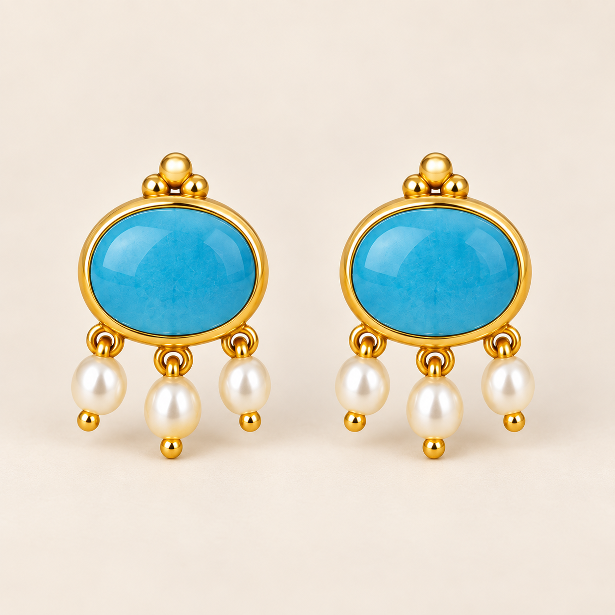 Ocean Pearl pair: oval turquoise stones in gold bezels, each with three rounded pearl drops.